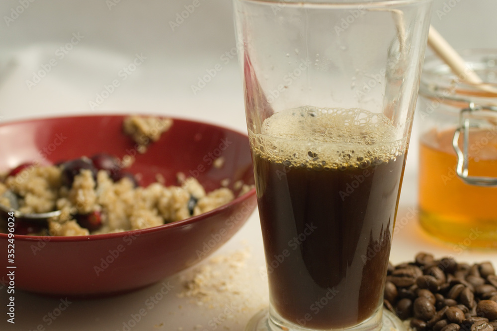 Fresh coffee with healthy breakfast of porridge, honey and medium shot Fresh coffee with healthy breakfast of porridge, honey and medium shot