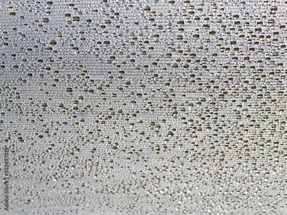 texture of water drops. A huge number of silver decorative sequins. Background texture with shiny, small elements that reflect sunlight in random order. Glitter, silver. selective focus. texture of water drops. A huge number of silver decorative sequins. Background texture with shiny, small elements that reflect sunlight in random order. Glitter, silver. selective focus.