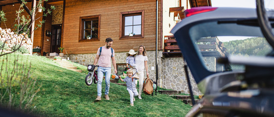 Family with two small children going on cycling trip in countryside.
