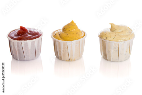 Set of three sauces, red tomato, mustard and bearnaise in recyclable paper cups, isolated on white background. photo