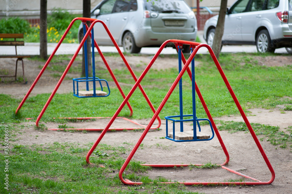 two swing red-blue in the playground two swing red-blue in the playground