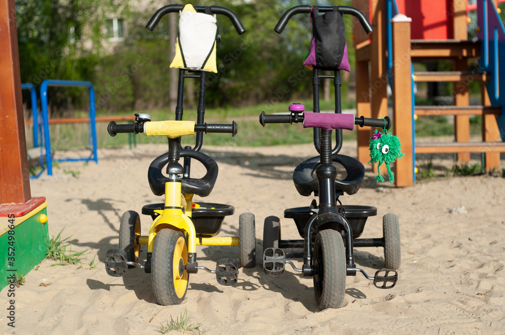 two bicycles are on the playground