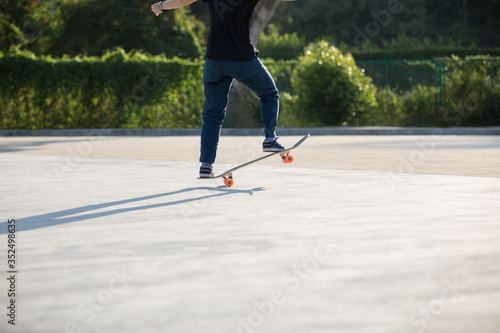 Skateboarder skateboarding at sunrise park