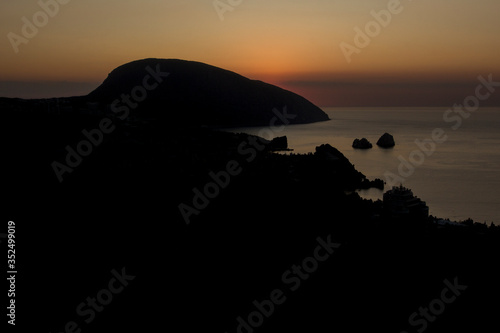 Mount Ayu-Dag silhouette at sunrise. View on Gurzuf Bay. Crimea.