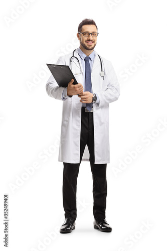 Male physician holding a document on a clipboard