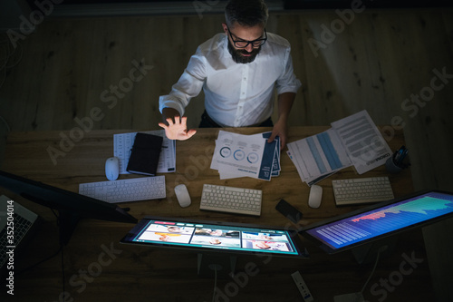 Top view of businessman with computer sitting at desk, video call concept.