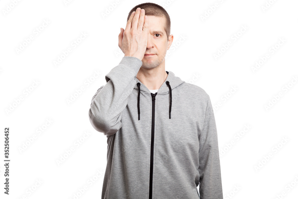 Dressed in a gray hooded jacket, short haircut. looking into the camera. Isolated Dressed in a gray hooded jacket, short haircut. looking into the camera. Isolated
