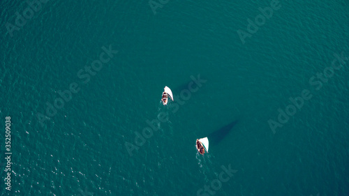 Boats on the sea with a birds eye view.