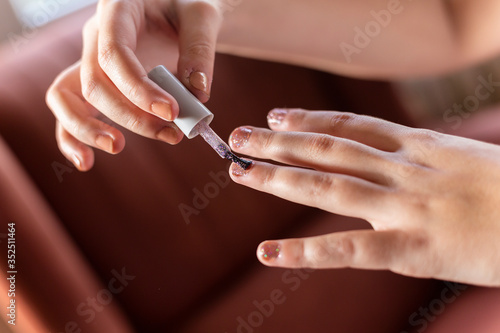 woman applying nail polish