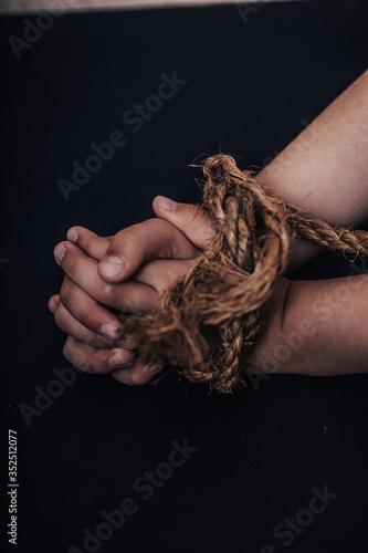 International human rights or refugee day concept. Closeup woman hands were tied with a rope.