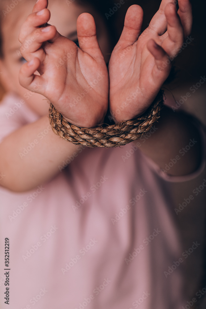 International human rights or refugee day concept. Closeup woman hands were tied with a rope.