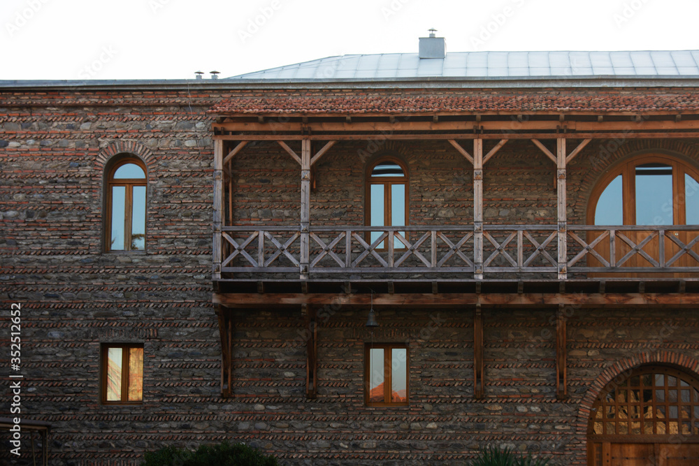 Wooden balcony and windows. Part of Svetitskhoveli Orthodox Cathedral castle fence in Mtskheta