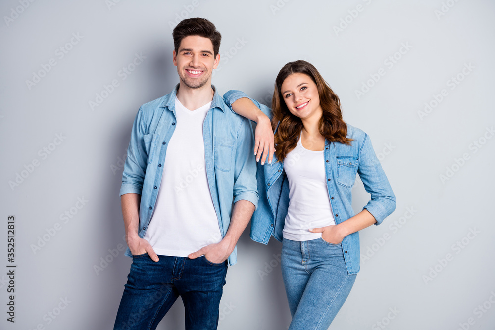 Portrait of friendly charming married couple enjoy summer rest together relax wear good look clothes isolated over gray color background Portrait of friendly charming married couple enjoy summer rest together relax wear good look clothes isolated over gray color background