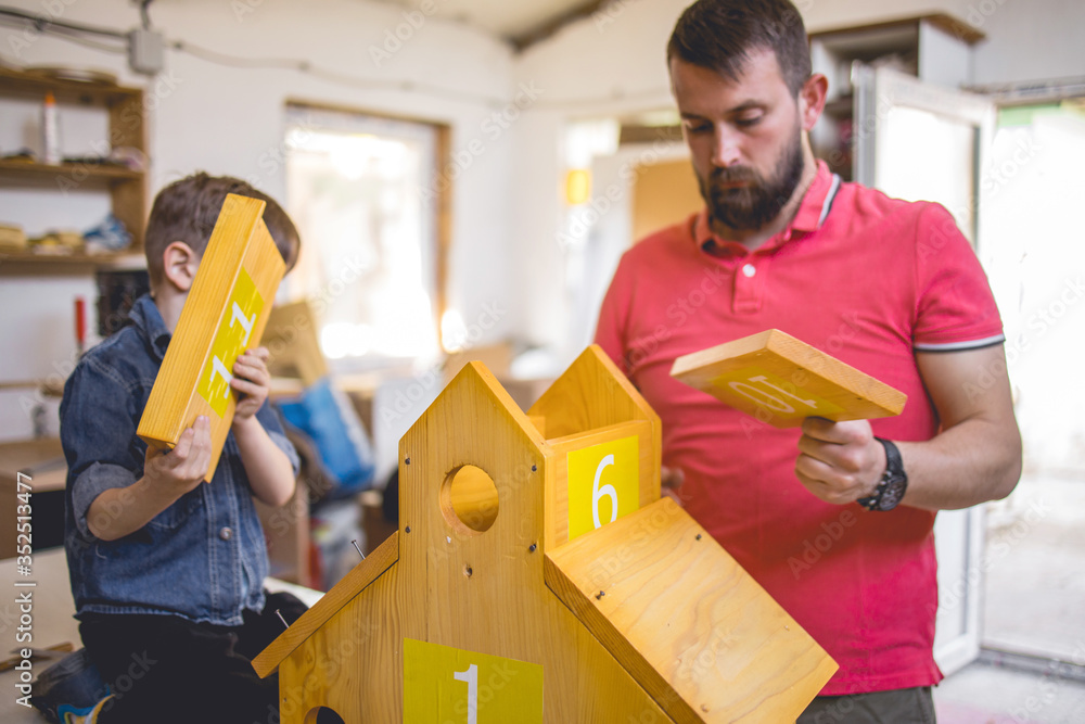 Father and Son Making a Birdhouse Father and Son Making a Birdhouse