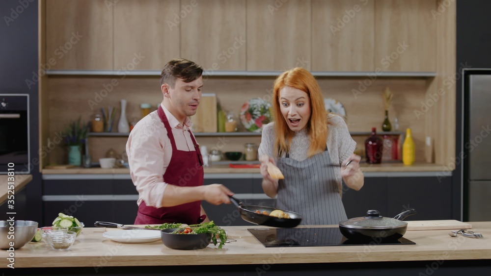Cooking show hosts chefs, male and female, cooking meat. Morning TV cooking programme Cooking show hosts chefs, male and female, cooking meat. Morning TV cooking programme