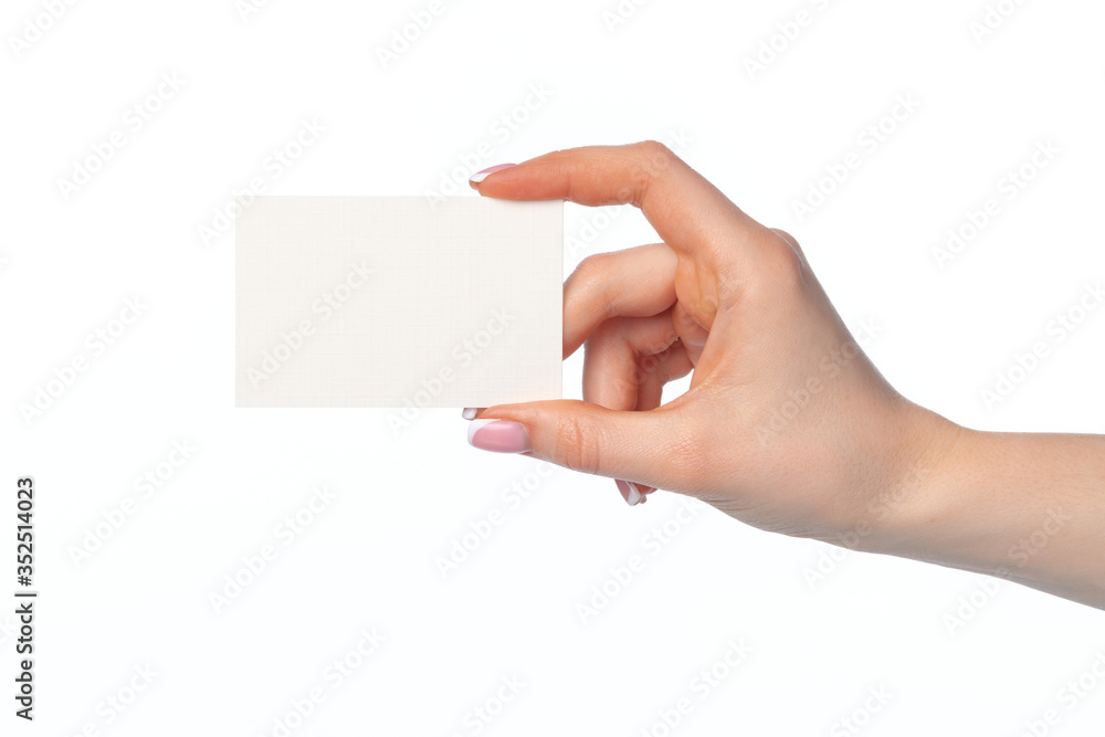 Female hand with blank white business card isolated on white Female hand with blank white business card isolated on white