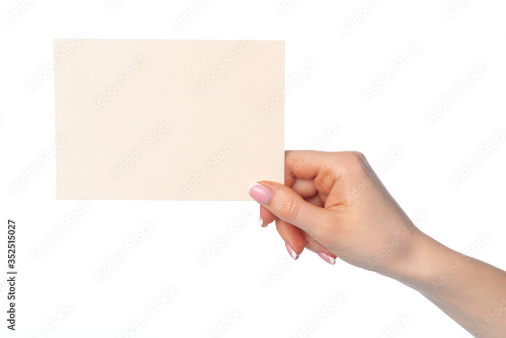 Female hand holding blank white sheet of paper isolated on white Female hand holding blank white sheet of paper isolated on white
