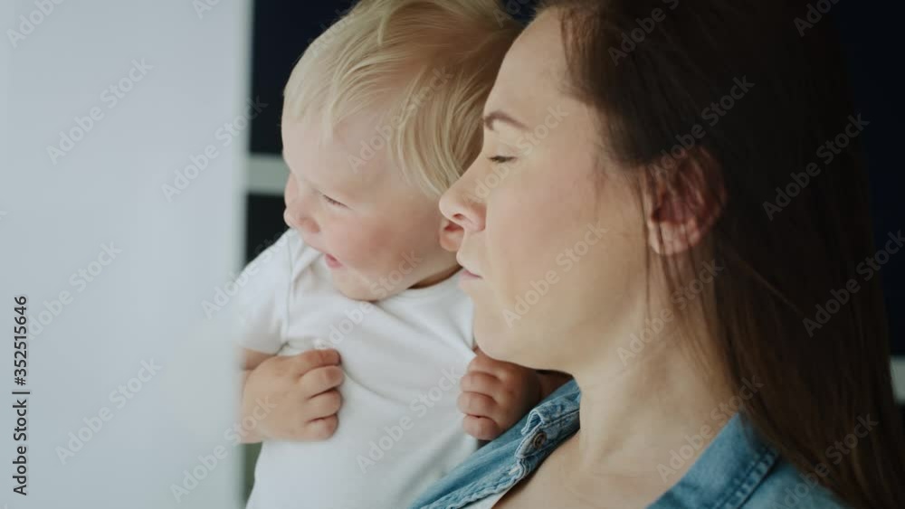 Close up video of mother and toddler looking through the window. Shot with RED helium camera in 8K Close up video of mother and toddler looking through the window. Shot with RED helium camera in 8K