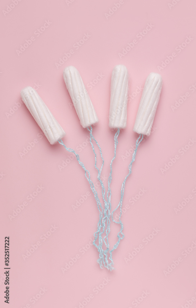 Protection concept for menstruation / tampons on a pink background. vertical photo Protection concept for menstruation / tampons on a pink background. vertical photo