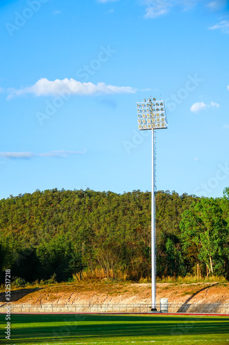 Running and football stadium sport light with blue sky background