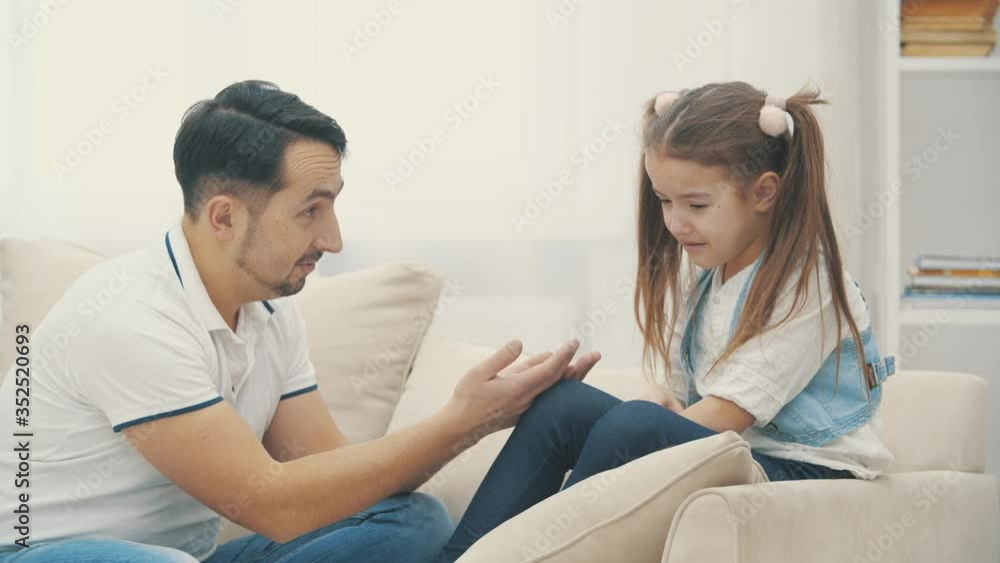 Daughter is sad and dad trying to please her in 4k slowmotion video. Daughter is sad and dad trying to please her in 4k slowmotion video.