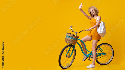 Hello, Summer. Positive Young Girl Riding Vintage Bicycle And Waving Hand