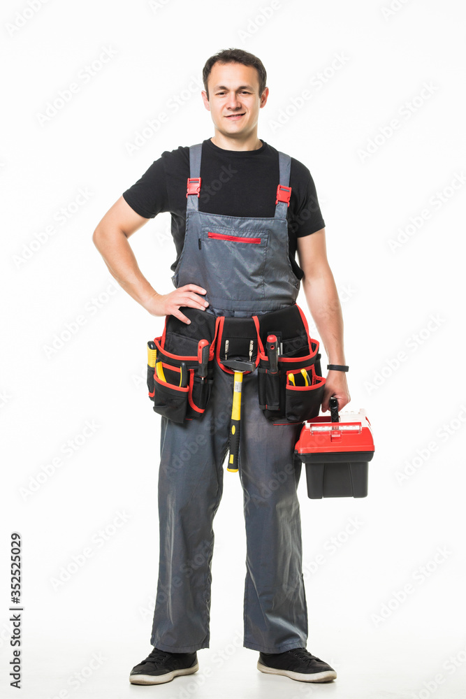 Young repair man talk phone with tools belt and box isolated on white background Young repair man talk phone with tools belt and box isolated on white background
