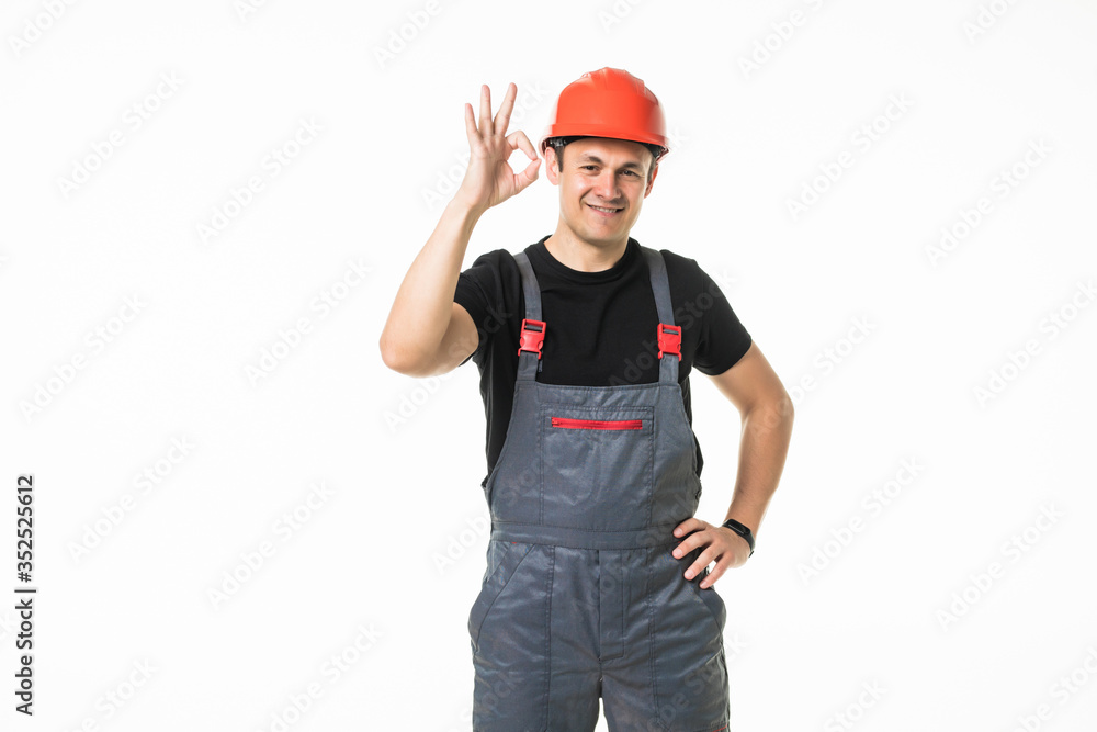 A man builder shows a hand gesture. Repair and construction isolated over white background
