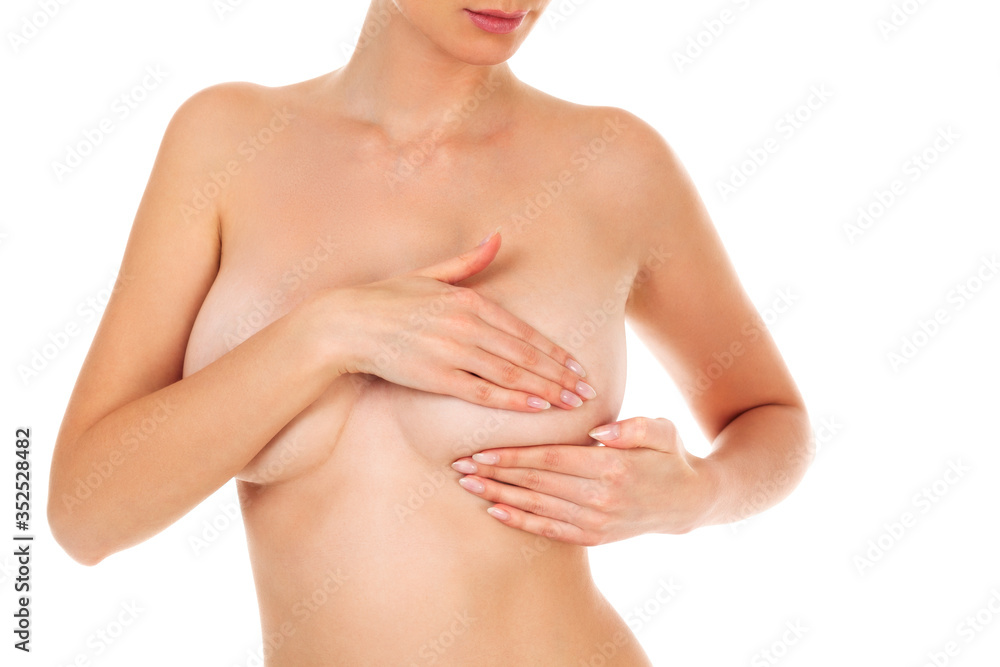 Fototapeta premium Woman controlling her breast for cancer, isolated on white background
