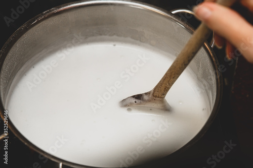 Принти на полотні Fresh cheese making step by step, heating milk into a saucepan, homemade cottage