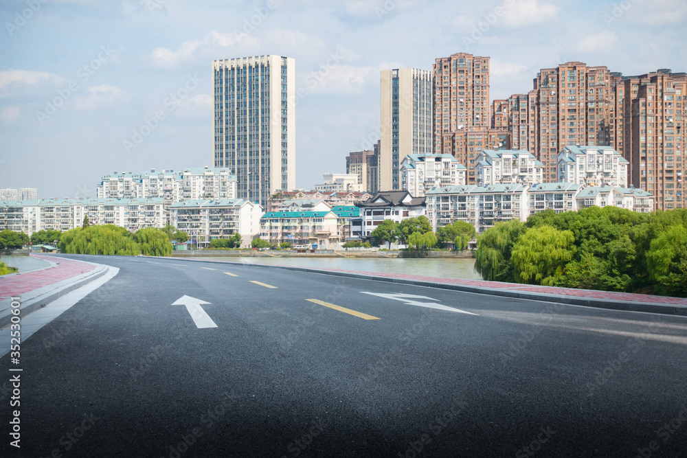 empty road with zebra crossing and skyscrapers in modern city