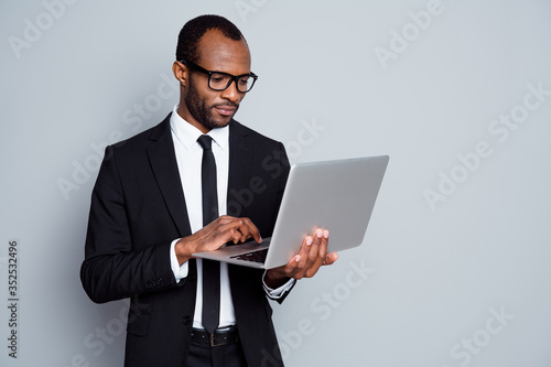 Portrait of his he nice attractive chic imposing bearded guy ceo boss chief banker financier company owner holding in hands laptop e-banking isolated on grey pastel color background
