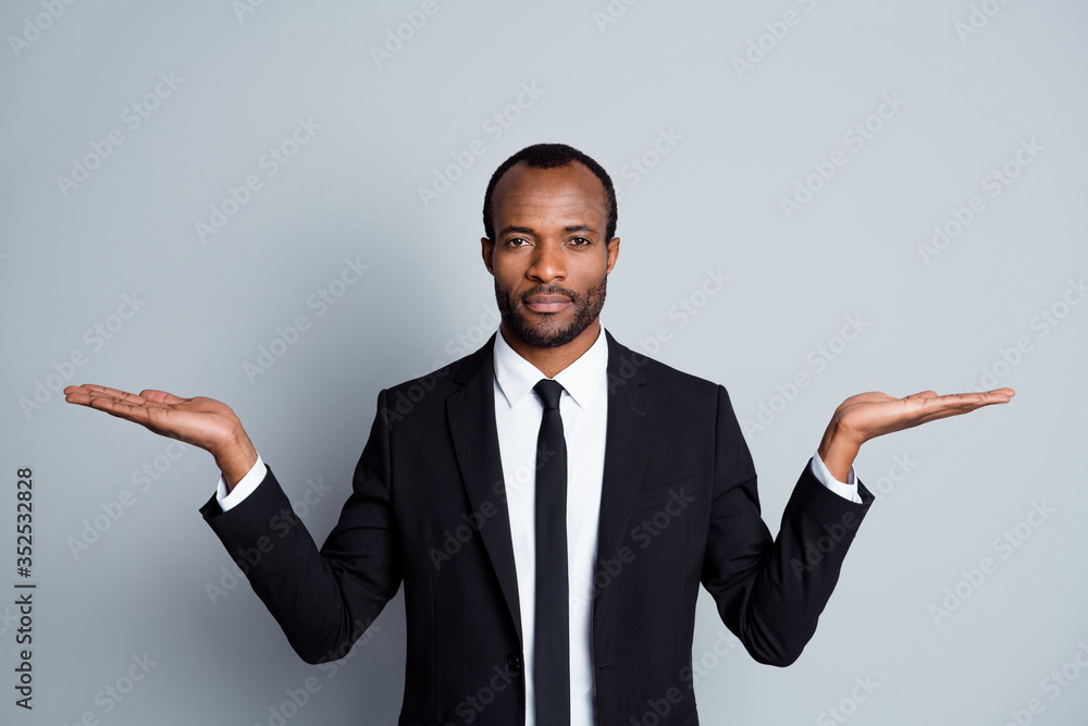 Close-up portrait of his he nice attractive serious imposing guy agent broker banker financier showing copy space on palms advice deposit capital isolated over grey pastel color background Close-up portrait of his he nice attractive serious imposing guy agent broker banker financier showing copy space on palms advice deposit capital isolated over grey pastel color background