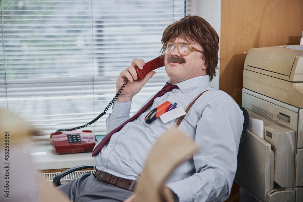 © Yakobchuk Olena - Big boss sitting in the office and enjoying pleasant phone talk