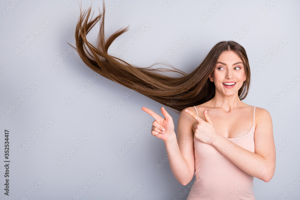 Fototapeta premium Close-up portrait of her she nice attractive lovely pretty cute cheerful brown-haired girl wind blowing hair showing new novelty solution isolated on light gray pastel color background