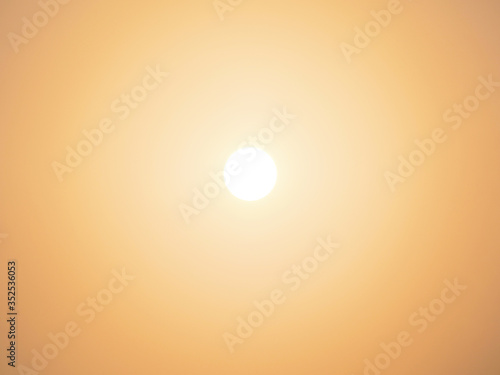 sun over golden clear sky background at sunrise