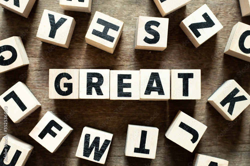 Letter block in word great with another block on wood background Letter block in word great with another block on wood background