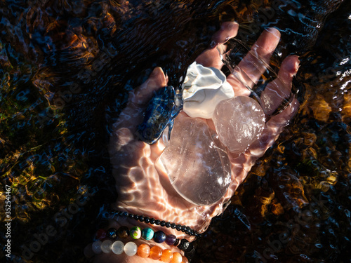 Stones in hand in water during energy cleanse