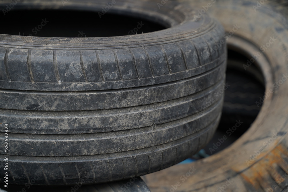 Fototapeta premium Old used tires in the garage 