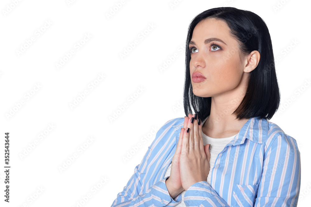 Portrait of young woman praying isolated on white background Portrait of young woman praying isolated on white background