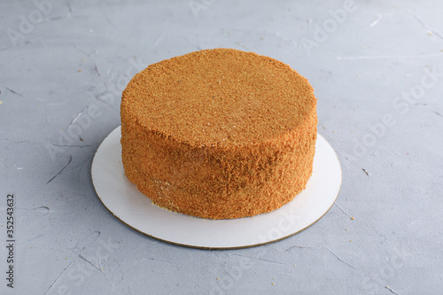 cake honey cake not cut on a gray background confectionery delivery of sweets