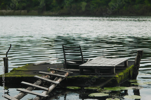 Old mossy overlay for fishing on the lake