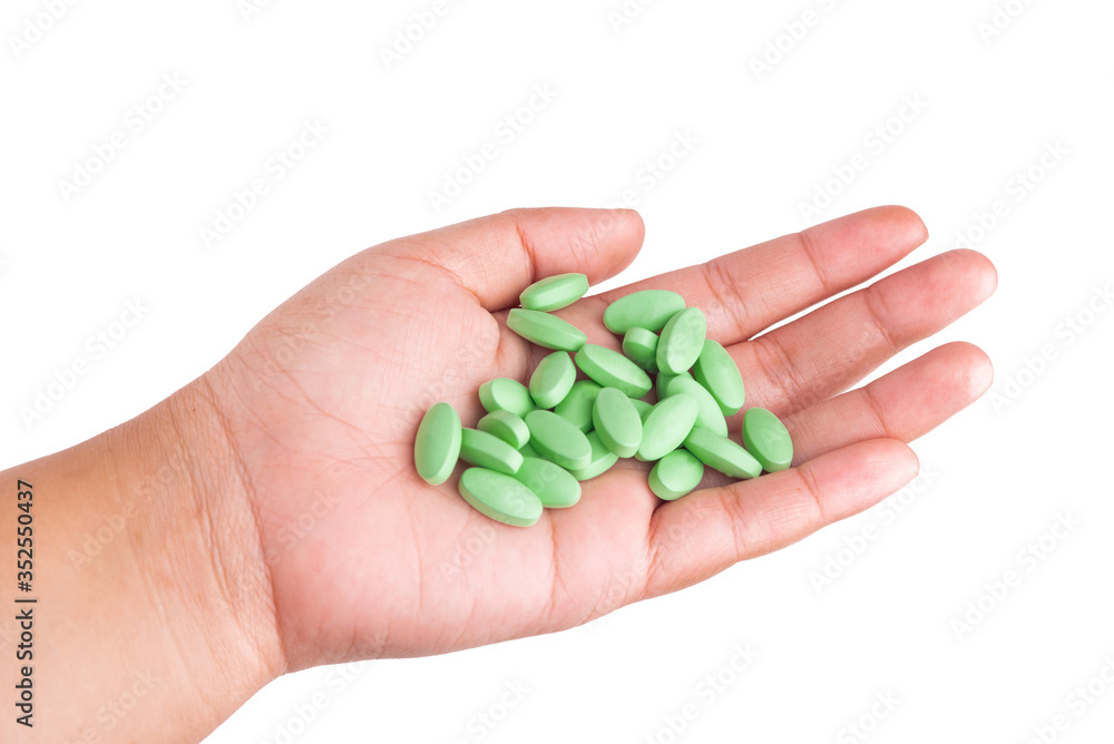 hand with green pills