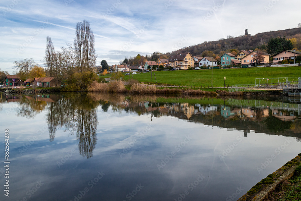 Reflections on the Étang des Forges lake in Belfort, France.