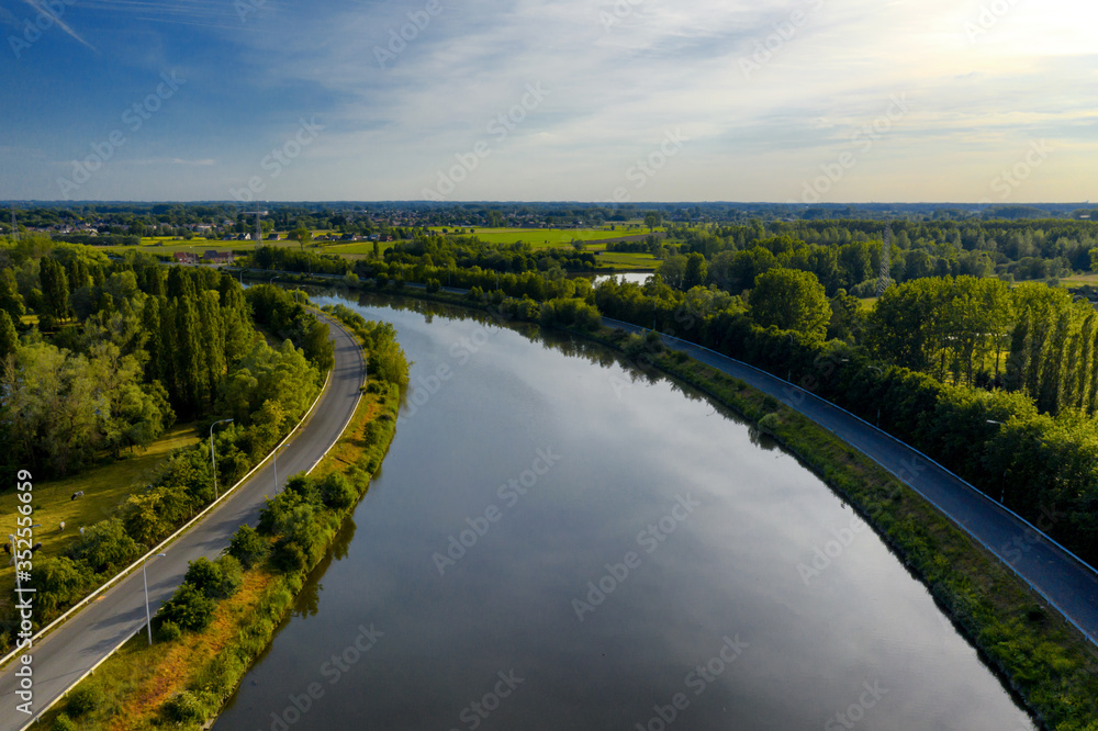 Curvy section of the Dender river, while passing the town of Dendermonde, in Belgium - aerial view