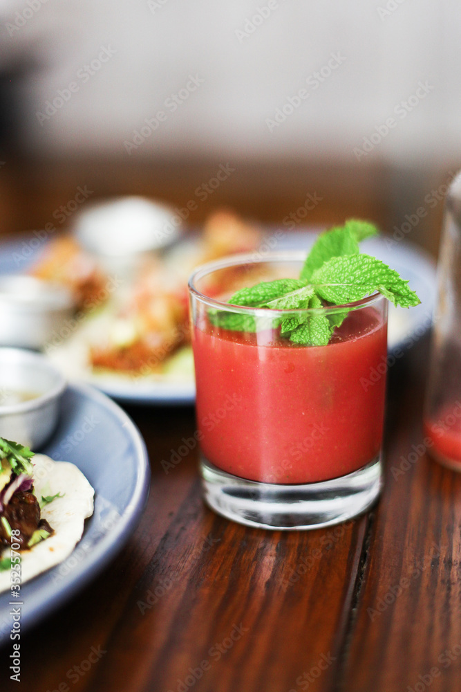 custom made wallpaper toronto digitalStrawberry juice with mint on top, next to food on a table in a cafe