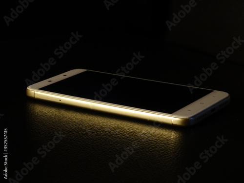 White smartphone isolated on black background