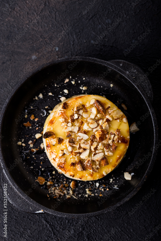Baked or fried Camembert or brie cheese with nuts and honey. Gourmet Breakfast. Baked or fried Camembert or brie cheese with nuts and honey. Gourmet Breakfast.