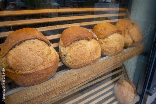 Showcase shelf with round breads in bakery. Closeup.