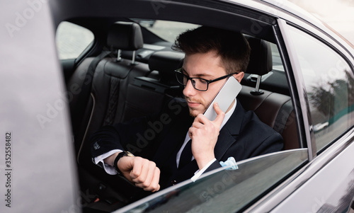 Young businessman talking on phone in car © Prostock-studio